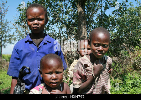 Meserani Snake Park, Arusha, Tanzania - February 14, 2008: Several African black children Maasai in ragged clothes. Stock Photo