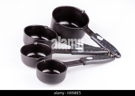 Set of black plastic measuring cups isolated on white background. Stock Photo