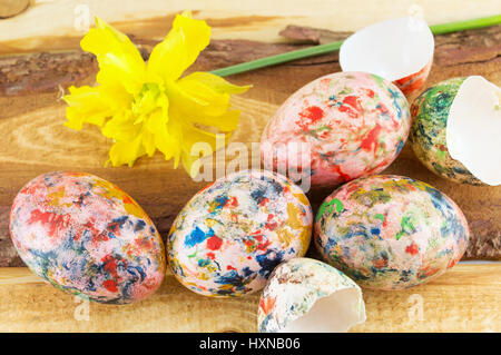 Hand painted Easter eggs and yellow narcissus flower Stock Photo