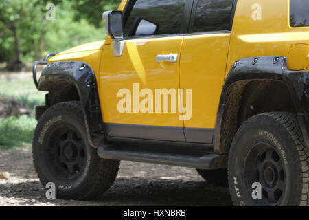 Yellow jeep parked in the fields Stock Photo