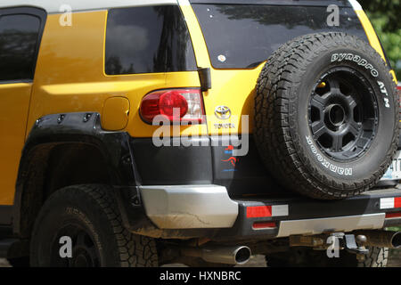 Yellow jeep parked in the fields Stock Photo