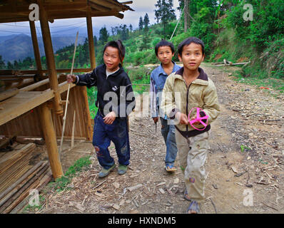 GUIZHOU, CHINA - APRIL 10: Ethnic Minorities in China, Three rural teenagers aged 12 years and stroll around the neighborhood of the village, April 10 Stock Photo