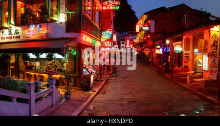 YANGSHUO TOWN , GUANGXI, CHINA - MARCH 30: Attractions in South China, popular with tourists from all over world. March 30, 2010. Yangshuo West Street Stock Photo