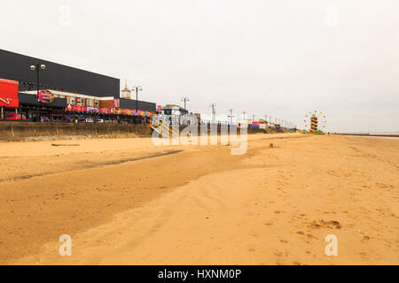 CLEETHORPES, ENGLAND - MARCH 14: Cleethorpes beach with ferris wheel and fairground in distance. In Cleethorpes, England. On 14th March 2017. Stock Photo