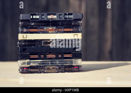 Filtered retro compact cassette audio magnetic tapes on wooden background Stock Photo