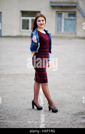 Young chubby teenage girl wear on red dress and jeans jacket posed against  school backyard Stock Photo - Alamy
