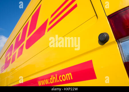 Side panel of a DHL delivery van. DHL is a division of the German logistics company Deutsche Post AG providing international express mail services. Stock Photo