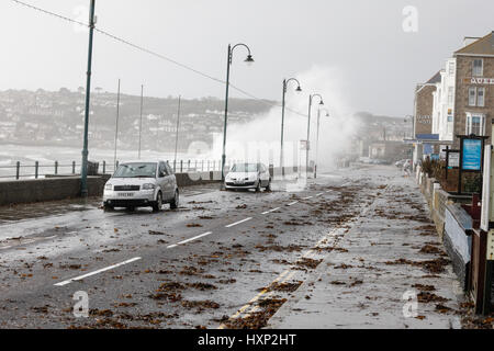 waves breaking over the seafront in Penzance during a winter storm Stock Photo