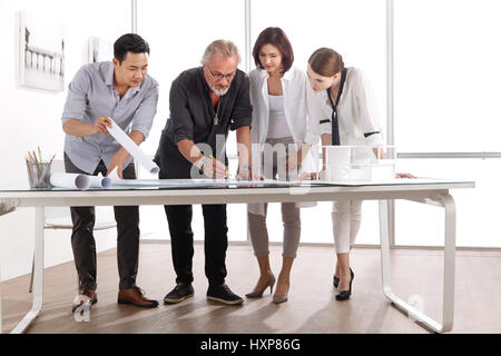 Architects working on blueprint Stock Photo