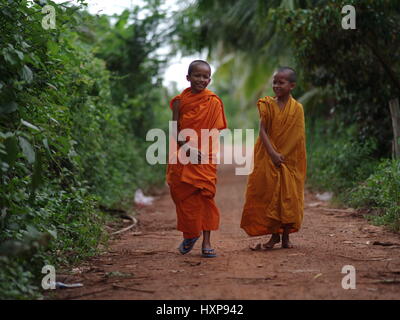 Monks on their way to Pagoda, South Cambodia.  Monks in Cambodia can range from very young boys to old men.  Many stay as Monks throughout their life. Stock Photo