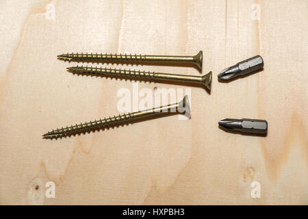 Screws and bits closeup on a wooden surface Stock Photo
