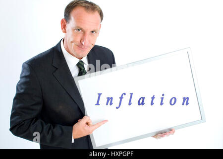 'Businessman holds writing board ''inflation'' (mr)', Geschäftsmann hält Schreibtafel 'Inflation' (mr) Stock Photo