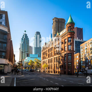 Gooderham or Flatiron Building in downtown Toronto with CN Tower on background - Toronto, Ontario, Canada Stock Photo