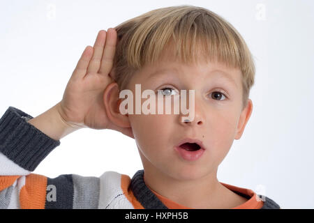 6-year-old boy holds hand to the ear (released), sechsjähriger Junge hält Hand an das Ohr (modell released) Stock Photo