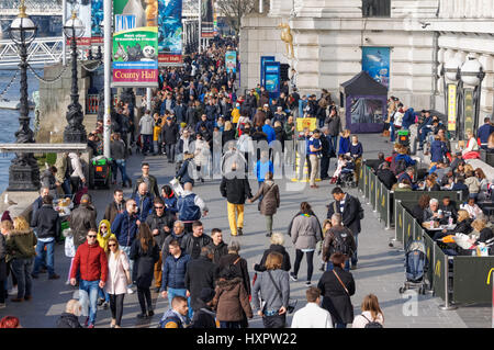People at the Queen's Walk promenade on the southern bank of the River Thames, London England United Kingdom UK Stock Photo