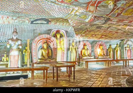 DAMBULLA, SRI LANKA - NOVEMBER 27, 2016: The masterpiece interior of Maharaja Lena Cave (Great Kings) of Dambulla Viharaya with statues and murals, on Stock Photo