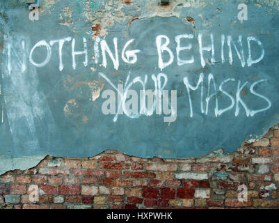 slogan sprayed on an old brick cement and blue painted wall in venice Stock Photo