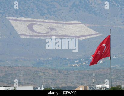 NORTH CYPRUS. Turkish flag flying on a building with a giant flag on south side of Besparmak range facing Nicosia and the Republic of Cyprus Stock Photo