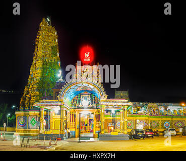 MATALE, SRI LANKA - NOVEMBER 27, 2016: The brightly illuminated facade of Muthumariamman Kovil - Tamil Hindu Temple, decorated with Gopuram tower, num Stock Photo