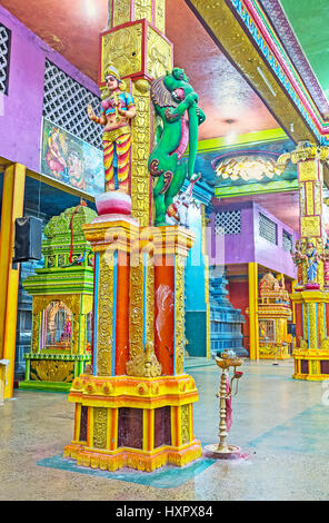 MATALE, SRI LANKA - NOVEMBER 27, 2016: The colorful pillar in Muthumariamman Kovil - Tamil Hindu Temple, decorated with carved patterns, sculptures an Stock Photo