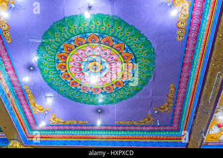 MATALE, SRI LANKA - NOVEMBER 27, 2016: The colorful ceiling of Muthumariamman Kovil - Tamil Hindu Temple decorated with rosette of peacock's feathers  Stock Photo
