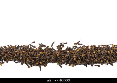 Whole Cloves in Row on Isolated White Background Stock Photo