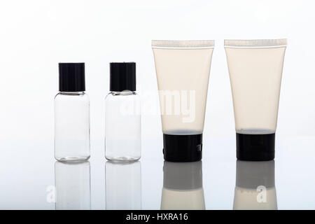 Empty transparent cosmetic bottles and tubes isolated on white background Stock Photo