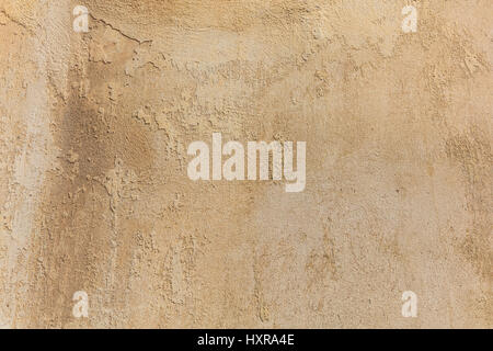 Worn pale yellow wall background, paint partly faded Stock Photo