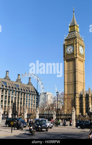 The Elizabeth Tower aka Big Ben on a sunny day with the London eye in the background and busy traffic. London, England 2017. Stock Photo
