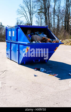 Ronneby, Sweden - March 27, 2017: Documentary of public waste station. Blue container for collecting used paper packages. Stock Photo