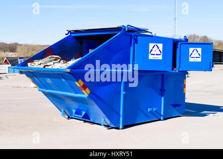 Ronneby, Sweden - March 27, 2017: Documentary of public waste station. Blue container for collecting used newspapers and magazines. Stock Photo