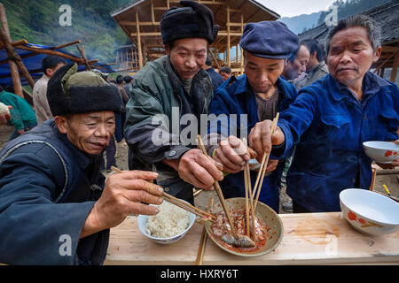Langde Village, Guizhou, China - April 16, 2010: Festive ceremony of the start of construction of  new peasant farmhouse, guests rural holiday togethe Stock Photo