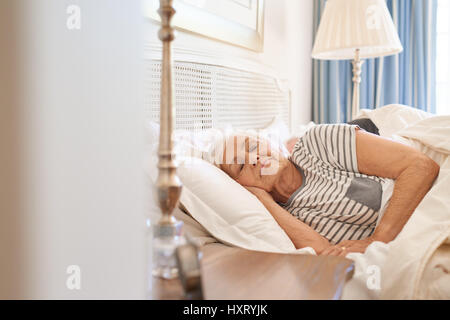 Senior couple fast asleep together in their bed  Stock Photo