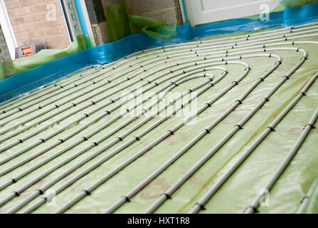 Installation of underfloor heating pipes pipe laid out on the inside of a house floor in a home England UK United Kingdom GB Great Britain Stock Photo