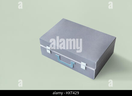 Closed Suitcase in Grey with Green Handle Isolated Stock Photo