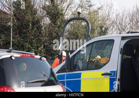 Peterborough, UK. 30th March 2017. Overturned truck at busy roundabout Peterborough. Traffic was held up as a truck overturned while turning in city centre roundabout. Police van arrives to direct traffic. Stock Photo