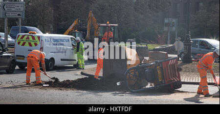 Peterborough, UK. 30th March 2017. Overturned truck at busy roundabout Peterborough. Traffic was held up as a truck overturned while turning in city centre roundabout. Police van arrives to direct traffic. Stock Photo