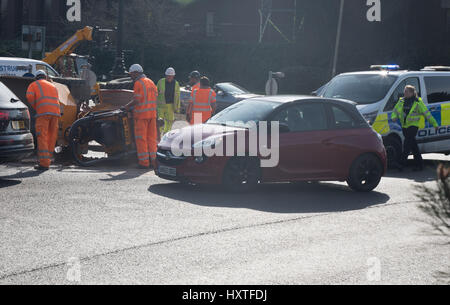 Peterborough, UK. 30th March 2017. Overturned truck at busy roundabout Peterborough. Traffic was held up as a truck overturned while turning in city centre roundabout. Police van arrives to direct traffic. Stock Photo