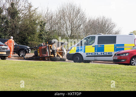 Peterborough, UK. 30th March 2017. Overturned truck at busy roundabout Peterborough. Traffic was held up as a truck overturned while turning in city centre roundabout. Police van arrives to direct traffic. Stock Photo