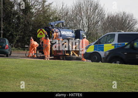 Peterborough, UK. 30th March 2017. Overturned truck at busy roundabout Peterborough. Traffic was held up as a truck overturned while turning in city centre roundabout. Police van arrives to direct traffic. Stock Photo