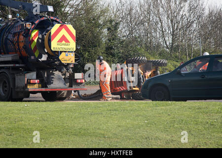 Peterborough, UK. 30th March 2017. Overturned truck at busy roundabout Peterborough. Traffic was held up as a truck overturned while turning in city centre roundabout. Police van arrives to direct traffic. Stock Photo