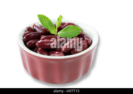 Closeup on red kidney beans in red bowl decorated with mint leaves on white background-healthy food concept Stock Photo