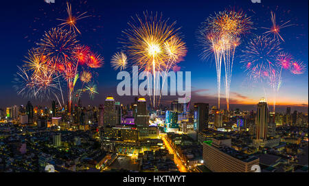 Beautiful firework in festival event exploding over the cityscape at twilight scene Stock Photo