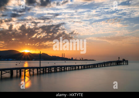 Majorca Puerto de Alcudia beach pier at sunrise in Alcudia bay in Mallorca Balearic islands of Spain Stock Photo