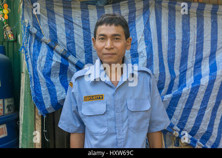 A poor Thai man poses at home in Phuket, Thailand. Nine is a security guard for a luxury property. 09-Mar-2017 Stock Photo