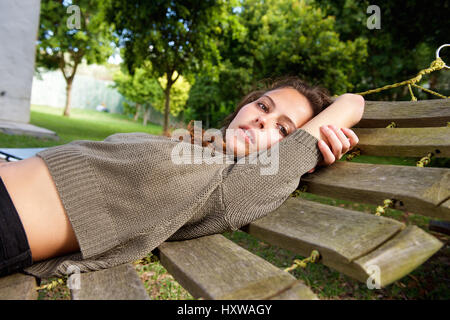 Portrait of a tired young woman lying on hammock Stock Photo