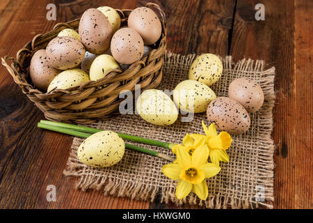 Easter eggs in basket. Retro decoration  pastel colors on old wooden table Stock Photo