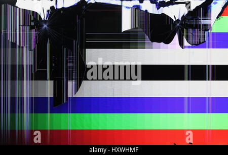 The LCD screen of the tv setis broken by shots from the traumatic gun. Color strips and pixels on color horizontal lines  test field signal Stock Photo
