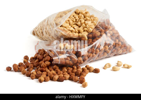 Cashew and hazelnuts in opened transparent zipper plastic bags over white Stock Photo