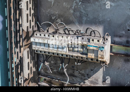 Deteriorate and dusty circuit breaker in a disused hangar Stock Photo